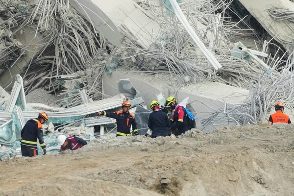 Rescuers search for victims at the damaged construction site of a high-rise building in Bangkok, Thailand, Saturday, March 29, 2025, following its collapse after Friday' earthquake. (AP Photo/Sakchai Lalit)
