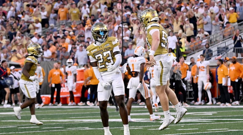 Georgia Tech defensive back Trae Stevenson Jr. (23) celebrates after scoring by Georgia Tech defensive back Elgin Sessions (not picgured) during the first half of an NCAA college football game at Bobby Dodd Stadium on Saturday, Sept. 12, 2026, in Atlanta.(Hyosub Shin/AJC)