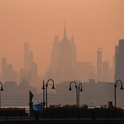 The New York City skyline is seen through a cover of wildfire smoke, in Jersey City, N.J., Friday, July 17, 2026. (AP Photo/Ryan Murphy)