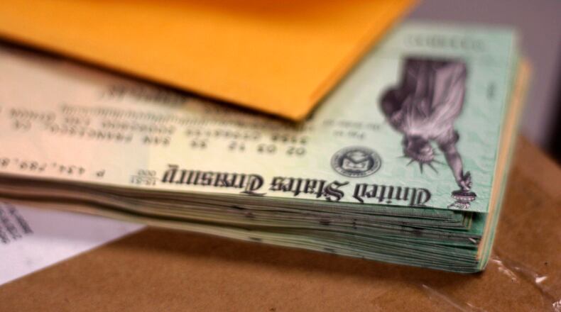 A stack of fraudulent IRS checks was evidence after the city of Elberton was bombarded by tax fraud in 2012. Bob Andres bandres@ajc.com