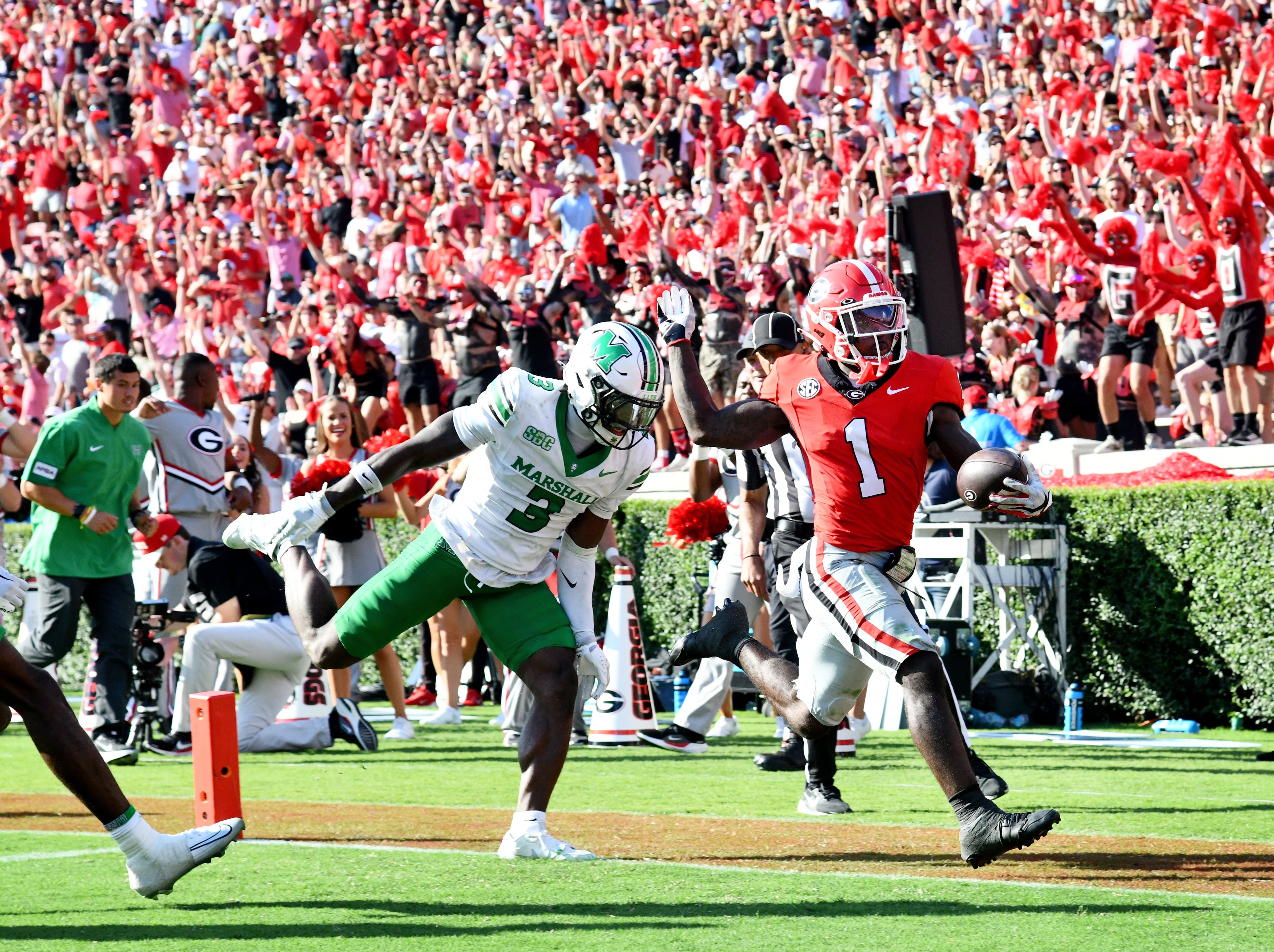 Georgia wide receiver Zachariah Branch (1) scores a touchdown past Marshall defensive back Marvae Myers (3) during the second half in an NCAA football game at Sanford Stadium, Saturday, August 30, 2025, in Athens. Georgia won 45-7 over Marshall. (Hyosub Shin / AJC)