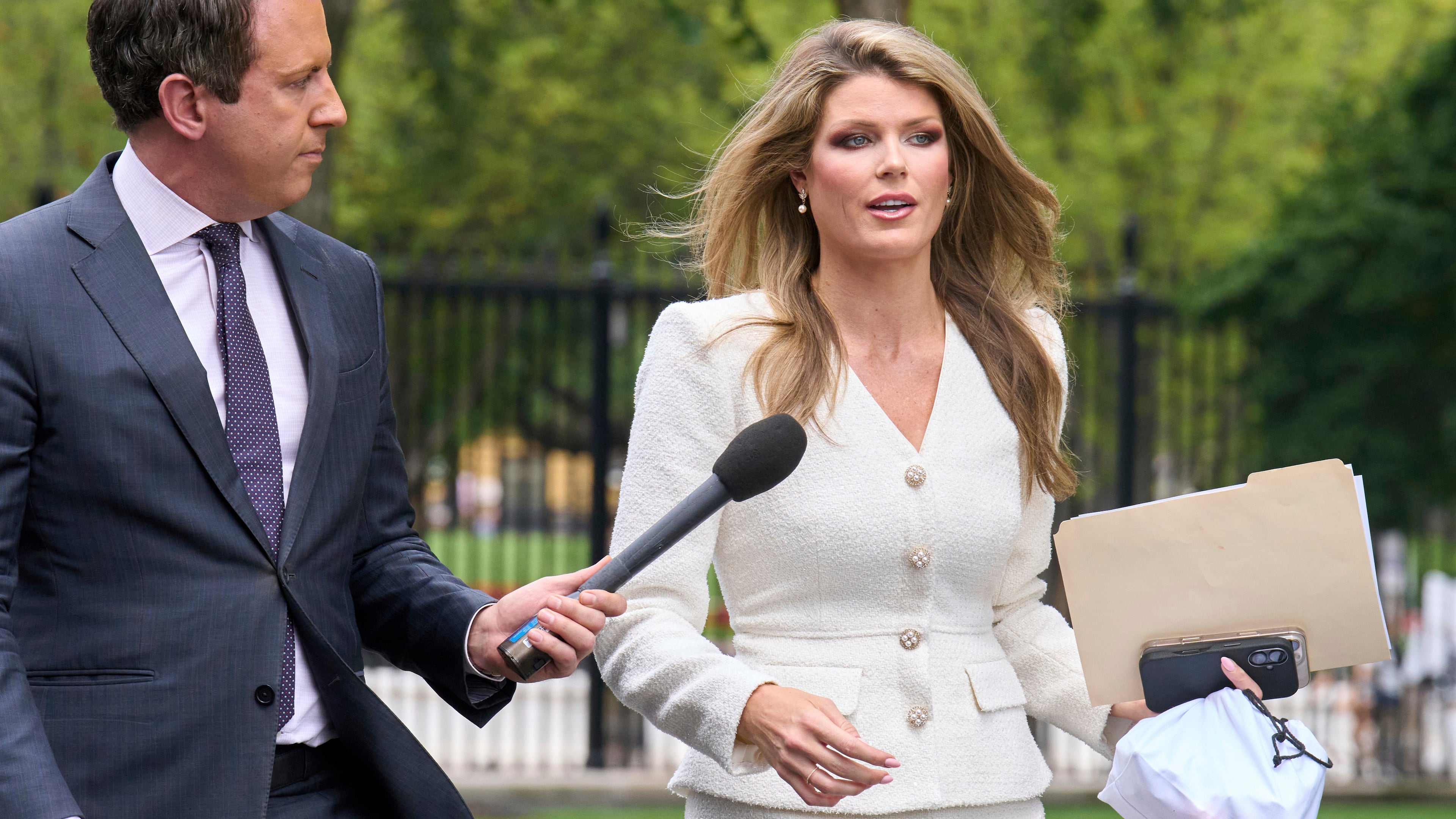 FILE - Lindsey Halligan, special assistant to the president, speaks with a reporter outside of the White House, Wednesday, Aug. 20, 2025, in Washington. (AP Photo/Jacquelyn Martin, File)