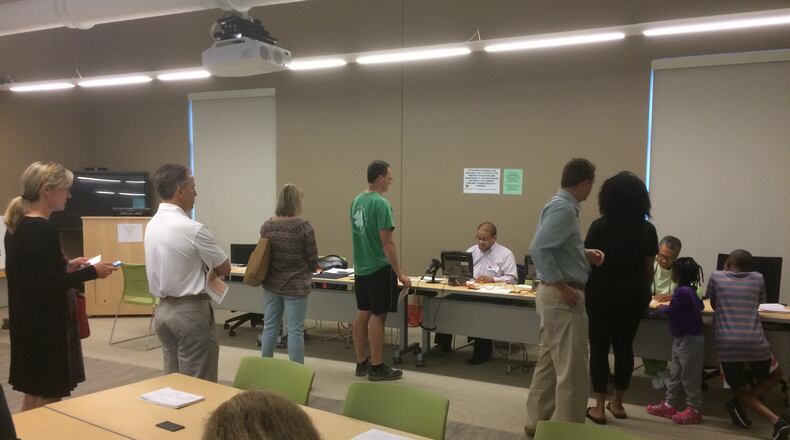 Voters wait to cast ballots at the Milton Library on April 18, 2017
