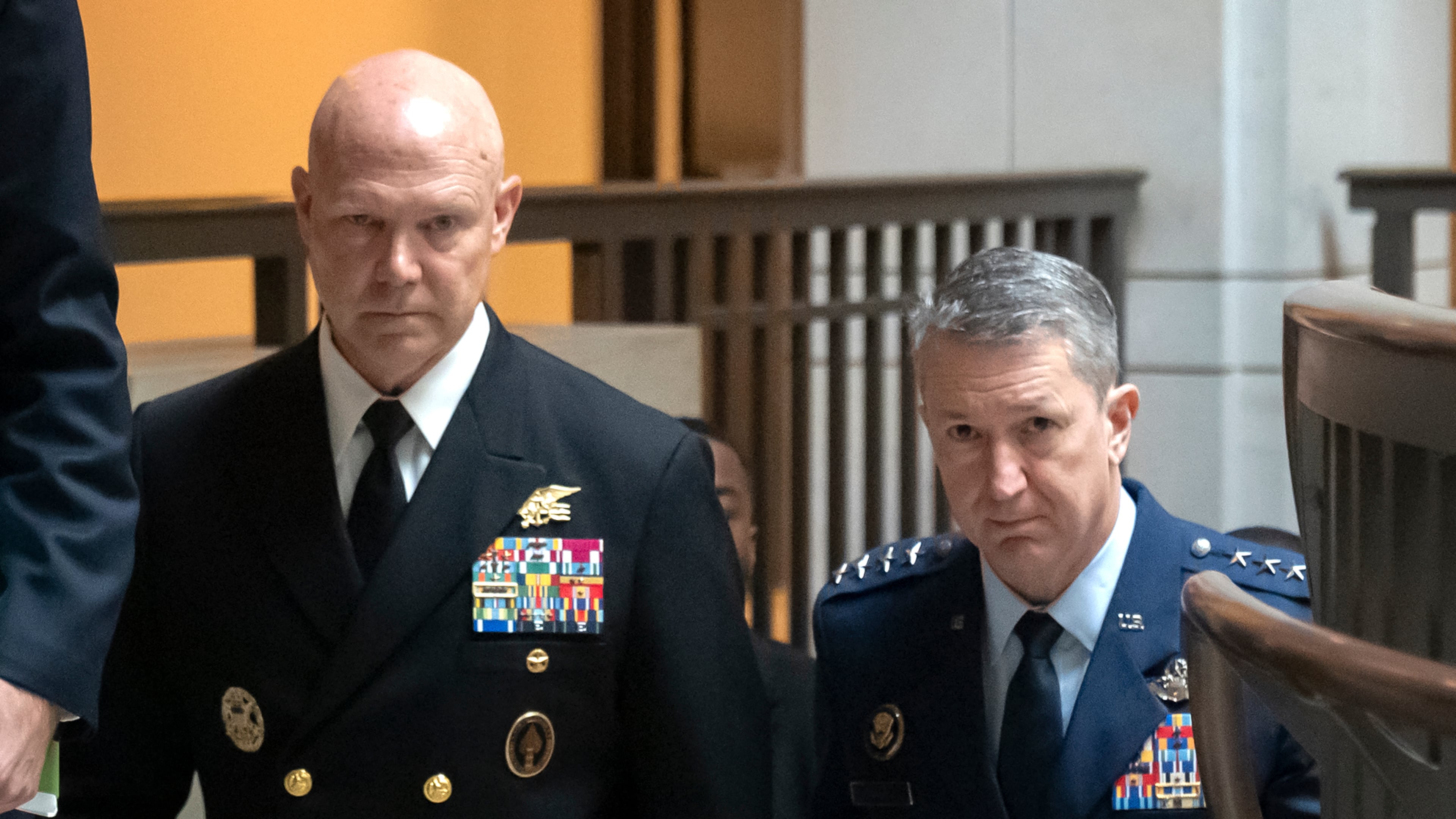 U.S. Navy Adm. Frank M. Bradley, accompanied by Gen. Dan Caine, chairman of the Joint Chiefs of Staff, right, walks to a meeting with senators on Capitol Hill, Thursday, Dec. 4, 2025, in Washington. (AP Photo/Mark Schiefelbein)