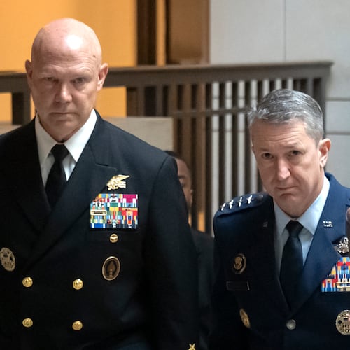 U.S. Navy Adm. Frank M. Bradley, accompanied by Gen. Dan Caine, chairman of the Joint Chiefs of Staff, right, walks to a meeting with senators on Capitol Hill, Thursday, Dec. 4, 2025, in Washington. (AP Photo/Mark Schiefelbein)