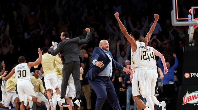 Georgia Tech players and coaches celebrate after defeating Notre Dame 62-60 in an NCAA college basketball game Saturday, Jan. 28, 2017, in Atlanta. (AP Photo/John Bazemore)