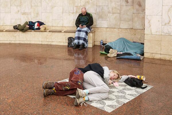Couple sleep on a floor as they take cover at a metro station during a Russian drone strike on Kyiv, Ukraine, Tuesday, June 10, 2025. (AP Photo/Evgeniy Maloletka)