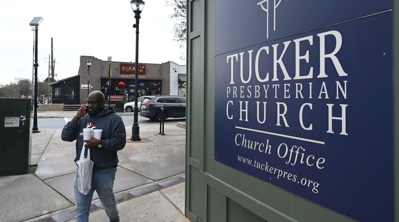 A pedestrian makes his way down Main Street in downtown Tucker in January. (Hyosub Shin/AJC)