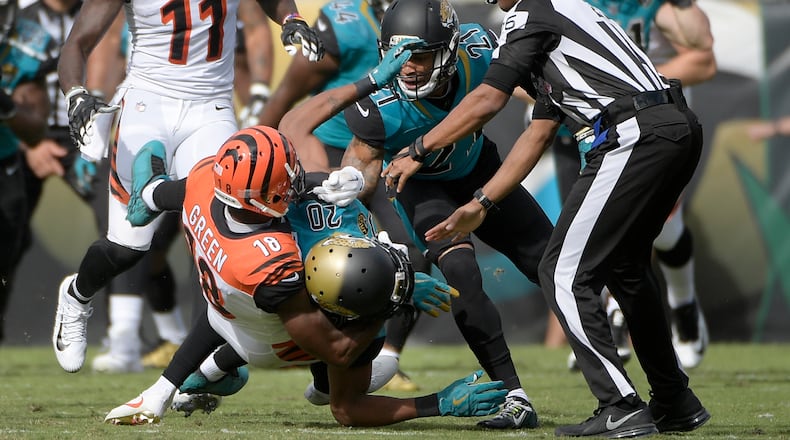 Cincinnati Bengals wide receiver A.J. Green (18) takes down Jacksonville Jaguars cornerback Jalen Ramsey (20) during a fight in the first half of an NFL football game Sunday, Nov. 5, 2017, in Jacksonville, Fla. (AP Photo/Phelan M. Ebenhack)