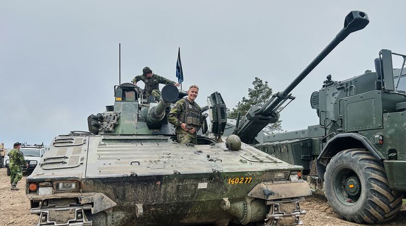 Swedish servicemen looks out of an armoured vehicle during a military exercises in Gotland, Sweden, Monday, May 11, 2026. (AP Photo/Emma Burrows)