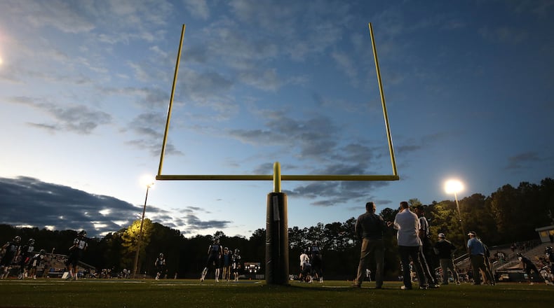 The sun sets before the high school football game between Pope and Centennial in this 2017 file photo