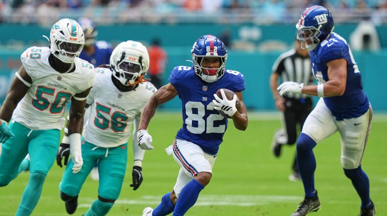 New York Giants wide receiver Calvin Austin III (82) runs the ball during the first half of a preseason NFL football game against the Miami Dolphins, Saturday, Aug. 22, 2026, in Miami Gardens, Fla. (AP Photo/Lynne Sladky)