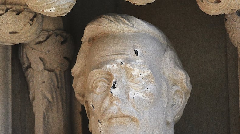 In this Aug. 17, 2017 photo, the defaced Gen. Robert E. Lee statue stands at the Duke Chapel in Durham, N.C. Duke University removed the statue Aug. 19, days after it was vandalized amid a national debate about monuments to the Confederacy. The university said it removed the carved limestone likeness early Saturday morning from where it had stood among 10 historical figures depicted in the entryway (Bernard Thomas/The Herald-Sun via AP)