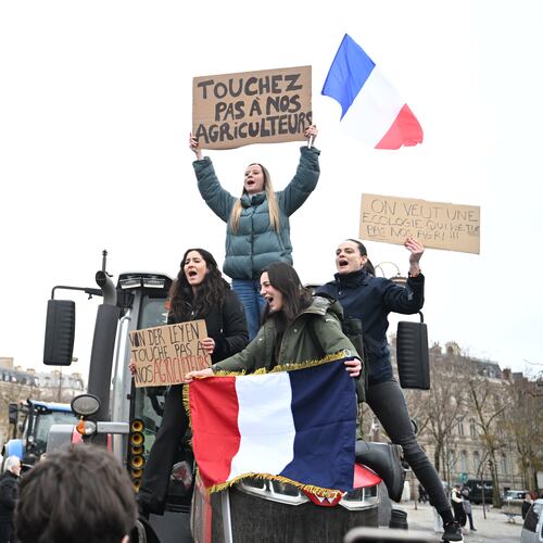 Women atop a tractor support farmers as they protest at the Arc de Triomphe against against the European Union's negotiations over the Mercosur trade deal with five South American nations, Thursday, Jan. 8, 2026 in Paris. (AP Photo/Emma Da Silva)