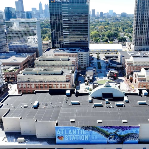 An aerial image shows the main square at Atlantic Station with the Atlanta skyline in the background on Thursday, Oct. 16, 2025. The shopping district is celebrating 20 years of dedication to hospitality and entertainment, an area that has significantly shaped the local landscape. (Miguel Martinez/AJC)