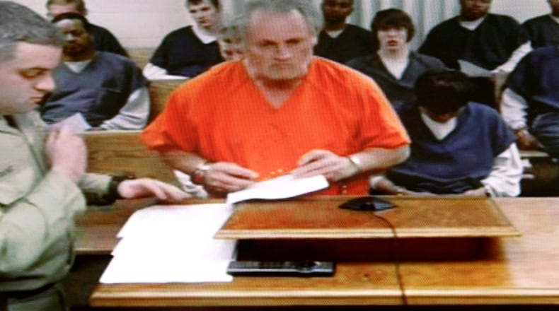 Jesse James Warren, 60, appeared on Cobb County court Wednesday via video. Police say he opened fire at a Kennesaw truck rental and leasing company, killing three men and critically wounding two others.