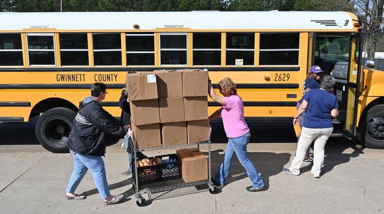 Gwinnett County School Bus drivers and staff load school buses with foods to deliver free meals to students in March 20, 2020.  (Hyosub Shin / Hyosub.Shin@ajc.com)