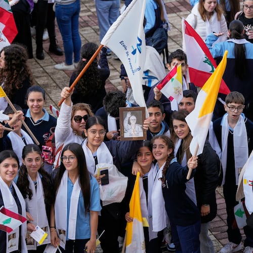 People wait for the arrival of Pope Leo XIV at the De la Croix hospital in Jal el Dib, Lebanon, Tuesday, Dec. 2, 2025. (AP Photo/Hassan Ammar)