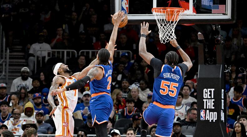 Knicks guard Miles McBride blocks a shot attempt by Hawks guard Nickeil Alexander-Walker during the second half of Game 6 of their first-round NBA playoff series at State Farm Arena on Thursday, April 30, 2026, in Atlanta. New York Knicks won 140-89 over Atlanta Hawks. (Hyosub Shin/AJC)