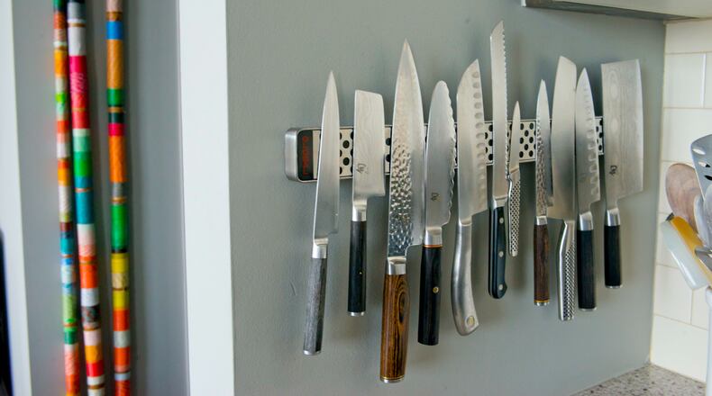 Homeowner and restaurant co-owner Ross Jones borrowed the idea of affixing kitchen knives to the wall with a magnet from her restaurant downstairs, Watershed on Peachtree. She likes the display and says it is less dangerous than storing knives in drawers.