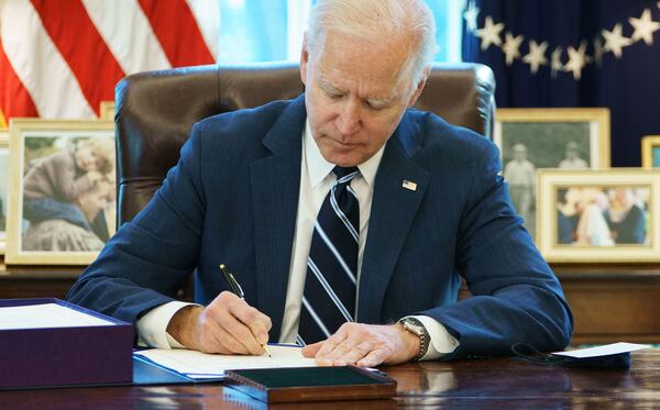 Former President Joe Biden signs the American Rescue Plan on March 11, 2021, in the Oval Office of the White House in Washington, D.C. (Mandel Ngan/Getty Images)