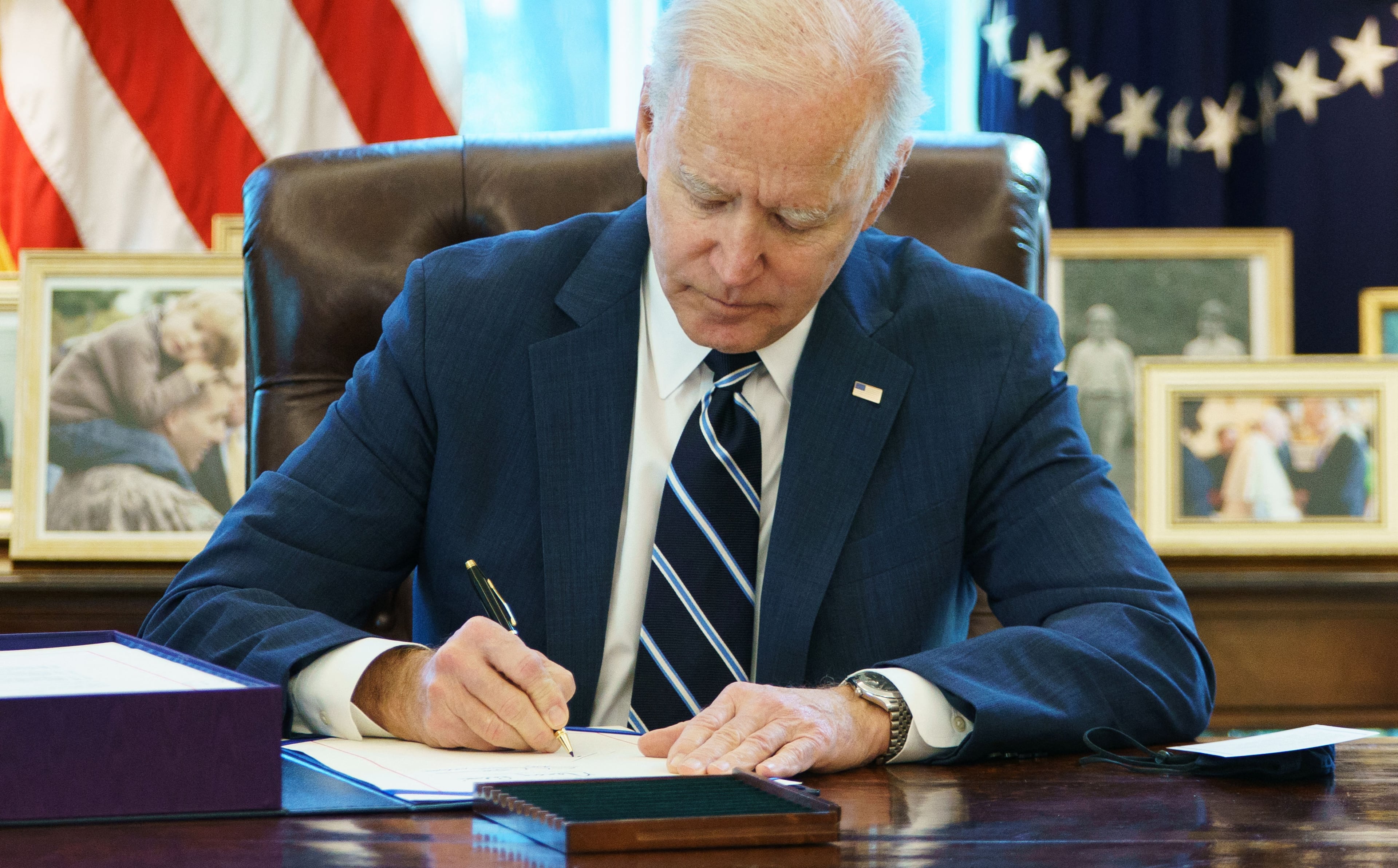 Former President Joe Biden signs the American Rescue Plan on March 11, 2021, in the Oval Office of the White House in Washington, D.C. (Mandel Ngan/Getty Images)