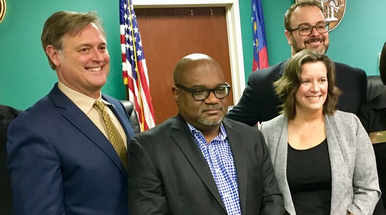 New Avondale Estates Commissioners Lionel Laratte and Lisa Shortell stand between Mayor Johnathan Elmore (left) and new Mayor Pro Tem Brian Fisher. Bill Banks for the AJC