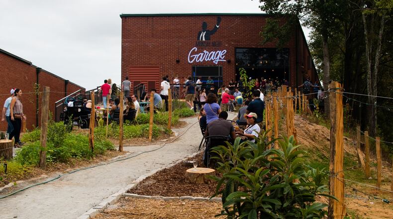 The path into the Monday Night Garage is lined with seating and fire pits, and there’s a dedicated space for cornhole.