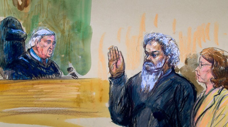 This June 28, 2014, artist's rendering shows United States Magistrate, Judge John Facciola, swearing in the defendant, Libyan militant Ahmed Abu Khatallah, wearing a headphone, as his attorney Michelle Peterson watches during a hearing at the federal U.S. District Court in Washington. (AP Photo/Dana Verkouteren)