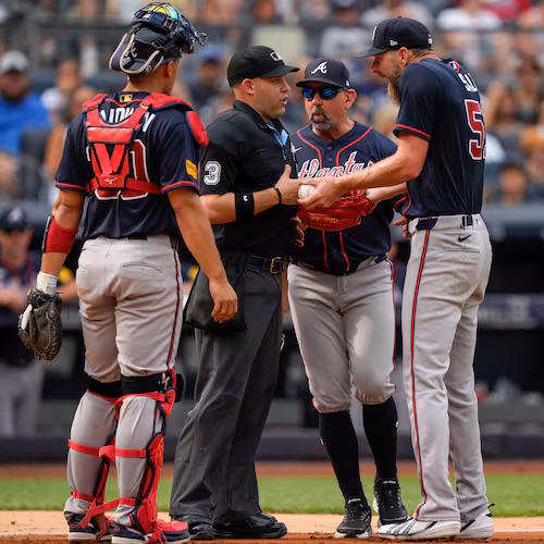 Atlanta Braves pitcher Chris Sale, right, argues with home plate umpire Dan Merzel, second left, during the fifth inning of a baseball game against the New York Yankees, Saturday, Aug. 8, 2026, in New York. (AP Photo/Yuki Iwamura)