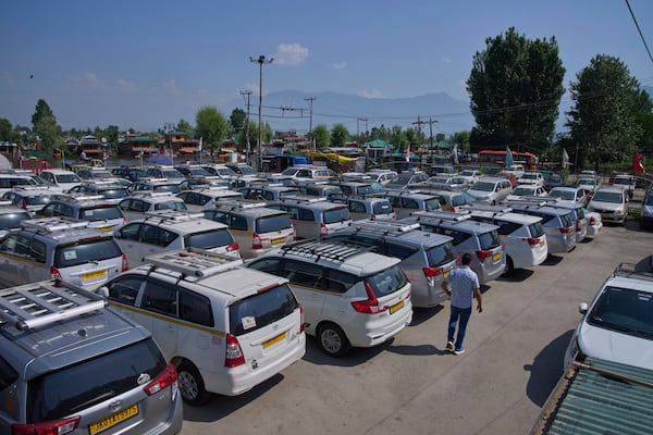 A Kashmiri taxi driver walks past hundreds of tourist cabs parked idle in Srinagar, Indian controlled Kashmir, India, Tuesday, May 20, 2025. (AP Photo/Dar Yasin)