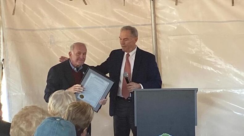 Upon the opening of "The Buzz" recreation center in his honor, former Cherokee County Board of Commissioners Chairman L.B. "Buzz" Ahrens Jr. (l) received a proclamation from Cherokee BOC Chairman Harry B. Johnston. (Courtesy of Cherokee County)