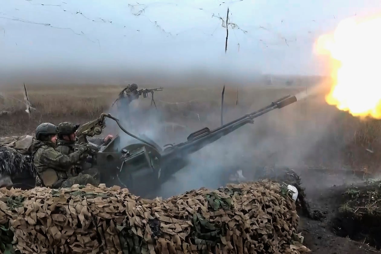 In this image made from video provided by Russian Defense Ministry Press Service on Friday, Nov. 7, 2025, Russian army soldiers fire to shoot a Ukrainian drone on an undisclosed location in Ukraine. (Russian Defense Ministry Press Service via AP)