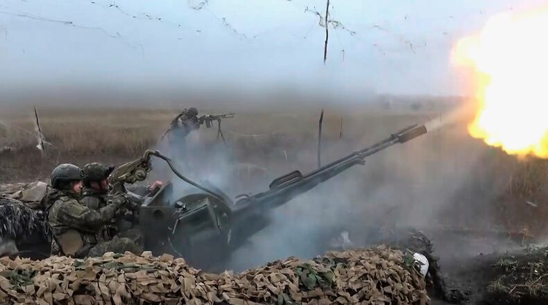 In this image made from video provided by Russian Defense Ministry Press Service on Friday, Nov. 7, 2025, Russian army soldiers fire to shoot a Ukrainian drone on an undisclosed location in Ukraine. (Russian Defense Ministry Press Service via AP)