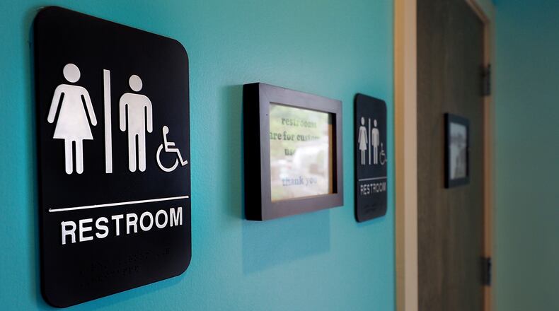 Unisex signs hang outside bathrooms at a restaurant in Durham, N.C. (Sara D. Davis / Getty Images)