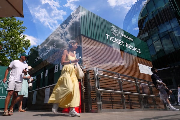 People pickup tickets at a Resale Office during the Wimbledon Tennis Championships in London, Thursday, July 3, 2025.(AP Photo/Kirsty Wigglesworth)