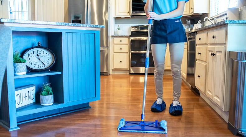 A MaidPro cleaner moves through a client's kitchen. The company, which opens its fourth Atlanta-area franchise on Friday, says it has enough demand to hire 25% more workers.