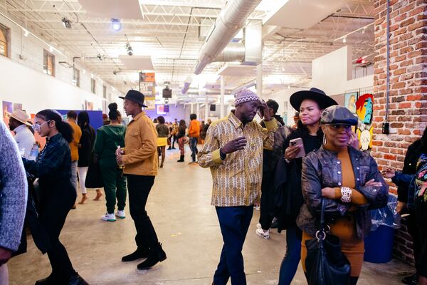 Audience members view works by artists at A Marvelous Black Boy Art Show.