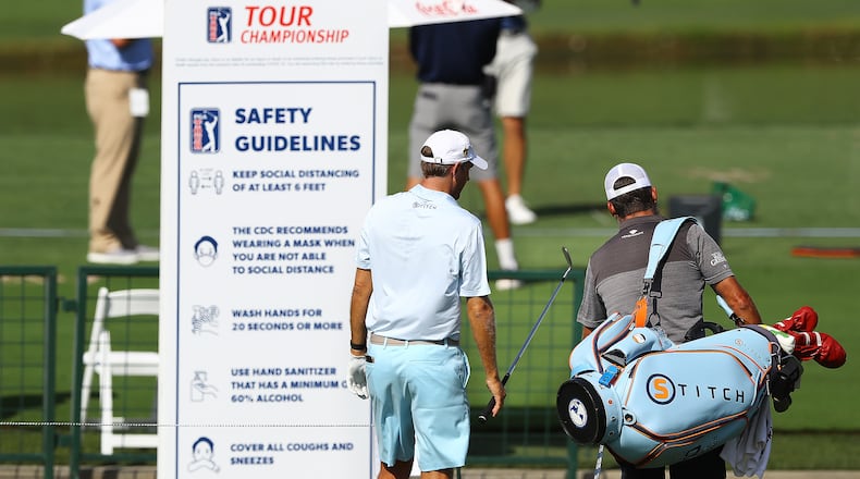 Brendon Todd walks past the safety guidelines board on his way to the driving range while preparing for the season-ending Tour Championship Sept. 2, 2020, at East Lake Golf Club in Atlanta. (Curtis Compton / Curtis.Compton@ajc.com)