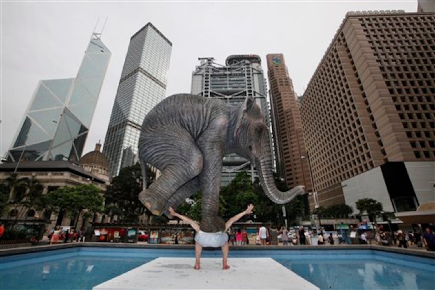 Statue of man balancing elephant