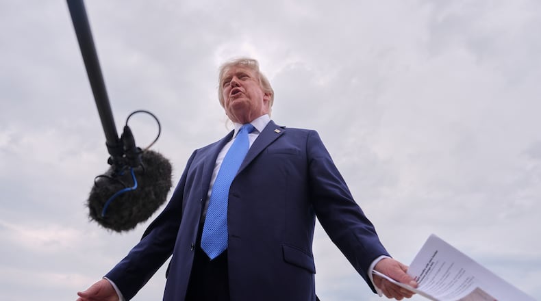 President Donald Trump speaks with reporters before boarding Air Force One, Friday, Aug. 14, 2026, at Joint Base Andrews, Md. (AP Photo/Julia Demaree Nikhinson)