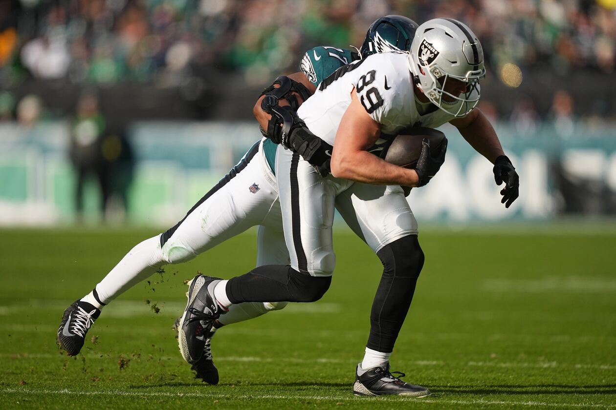 Raiders tight end Brock Bowers (front) is brought down by then-Eagles linebacker Nakobe Dean. Dean was traded from Philadelphia to Las Vegas and will be Bowers’ teammate this season. (Matt Rourke/AP 2025)