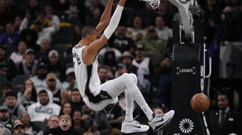 San Antonio Spurs forward Victor Wembanyama (1) scores against the Orlando Magic during the first half of an NBA basketball game in San Antonio, Sunday, Feb. 1, 2026. (AP Photo/Eric Gay)