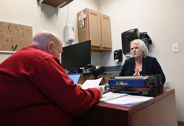 Dwayne Givens (left), Workforce Development Director, reads a resume of candidate Amy McEver as he interviews EcEver during Fulton County Board of Health Career Fair at North Fulton Regional Health Center, Tuesday, August 29, 2023, in Alpharetta. (Hyosub Shin / Hyosub.Shin@ajc.com)