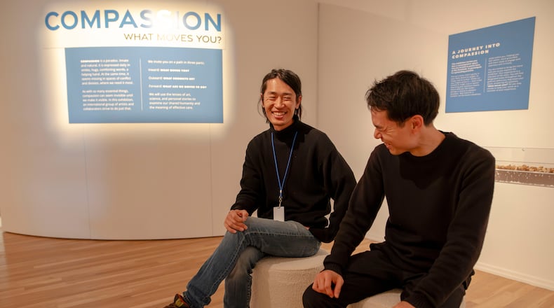Kosuke Matsushima (left) and Masashi Fujimoto of ARu Inc., a Japanese art collective, helped create a biometric-infused art installation measuring the collective heartbeats of visitors to the Michael C. Carlos Museum exhibition "Compassion: What Moves You?" (Isadora Pennington/Courtesy of ArtsATL)