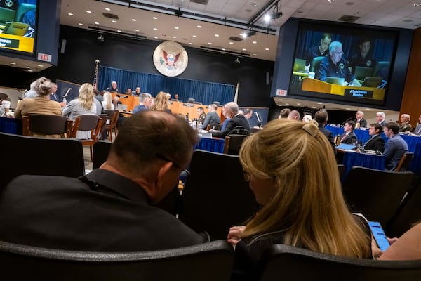 Tim and Sheri Lilley, father and stepmother of Flight 5342 First Officer Sam Lilley, sat up front through all three, 10-12 hour days of the NTSB hearings. The aging building's A/C and toilets struggled to handle the crush of attendees. (Craig Hudson for the AJC)