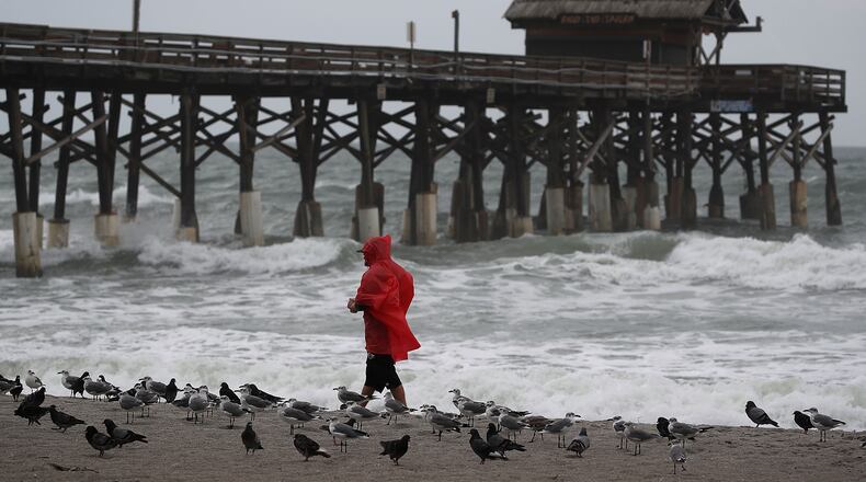 COCOA, FL - OCTOBER 06: A man walks near the Cocoa Beach Pier as Hurricane Matthew approaches, October 6, 2016 on Cocoa Beach, Florida. Hurricane Matthew is expected to reach the area later this afternoon bringing heavy wind, and widespread flooding. (Photo by Mark Wilson/Getty Images)