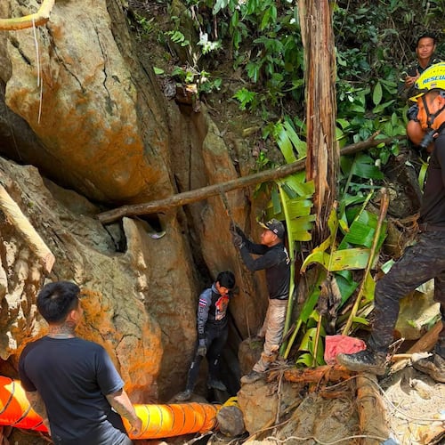 In this release Metta Tham Rescue Kalasin, rescuers work to reach seven people who have been trapped in a cave in Xaisomboun province, Laos, Monday, May 25, 2026. (Metta Tham Rescue Kalasin via AP)