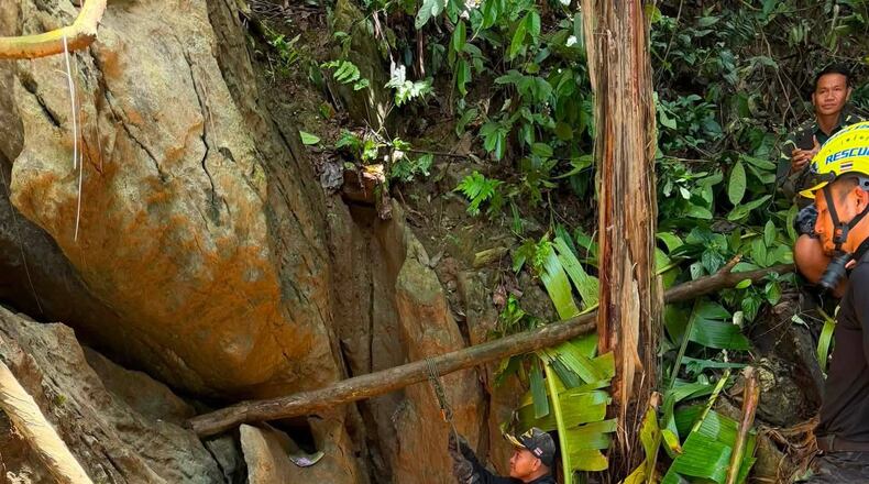 In this release Metta Tham Rescue Kalasin, rescuers work to reach seven people who have been trapped in a cave in Xaisomboun province, Laos, Monday, May 25, 2026. (Metta Tham Rescue Kalasin via AP)