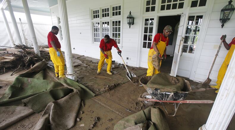 Debris is stacked up along the back of the golf academy as workers begin the cleanup of the Old White Course on the property of the Greenbrier Resort in White Sulphur Springs, W. Va., Tuesday, June 28, 2016. Flooding from heavy rains last week damaged the course canceling the PGA Tour event scheduled for next week and closing the Hotel. (AP Photo/Steve Helber)